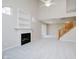 Spacious living room with a cozy fireplace, built-in shelves, and natural light at 9406 Avon Strand # Apt A, Avon, IN 46123