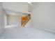 Open-concept living area with stairs, sliding glass doors, and modern lighting at 9406 Avon Strand # Apt A, Avon, IN 46123