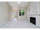 Inviting living area featuring fireplace, built-ins, and a view to the entrance at 9406 Avon Strand # Apt A, Avon, IN 46123
