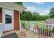 View of the back porch with brick siding and metal chairs, overlooking a large grassy yard at 9974 N 850 W, Fairland, IN 46126