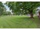 View of the expansive backyard with mature trees, manicured lawn and outbuilding at 9974 N 850 W, Fairland, IN 46126