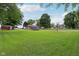 View of the expansive backyard featuring a play area, storage shed and a full-size basketball court at 9974 N 850 W, Fairland, IN 46126