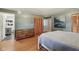 Comfortable bedroom with hardwood floors, neutral walls, and a glimpse into an attached bathroom at 9974 N 850 W, Fairland, IN 46126