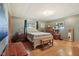 Comfortable bedroom with hardwood floors, a white bed frame, and natural light from two windows at 9974 N 850 W, Fairland, IN 46126