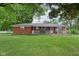 Charming brick home with a covered front porch and a lush green lawn at 9974 N 850 W, Fairland, IN 46126