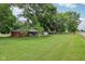 View of the home's front exterior and vast front yard with mature trees along the street at 9974 N 850 W, Fairland, IN 46126