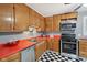 Functional kitchen featuring checkered floors and ample cabinet space at 9974 N 850 W, Fairland, IN 46126