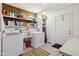 Functional laundry room equipped with a washer, dryer, sink, and ample shelving for storage at 9974 N 850 W, Fairland, IN 46126