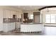 Modern kitchen with white cabinets, stylish backsplash, granite counters, and a central island at Lot 30 Doe Meadow, Anderson, IN 46011