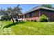 Spacious backyard with lush green lawn, brick exterior, and serene outdoor setting at 1027 Plum St # 39, Brownsburg, IN 46112