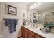 Bathroom vanity featuring wood cabinets, sink, and framed mirror at 1027 Plum St # 39, Brownsburg, IN 46112