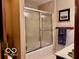 Neat bathroom featuring a shower-tub combo with glass doors and neutral tones at 1027 Plum St # 39, Brownsburg, IN 46112
