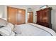 A charming bedroom featuring a closet with wooden doors and an elegant armoire with a built in TV at 1027 Plum St # 39, Brownsburg, IN 46112