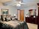 Bedroom showing ceiling fan, bed with decorative pillows, and a wooden dresser with mirror at 1027 Plum St # 39, Brownsburg, IN 46112