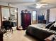 Cozy bedroom features a ceiling fan, armoire, and mirrored closet doors, offering ample storage at 1027 Plum St # 39, Brownsburg, IN 46112