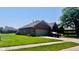 Attractive brick home with attached garage, well-maintained landscaping and paved driveway at 1027 Plum St # 39, Brownsburg, IN 46112