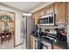 Well-equipped kitchen with stainless steel appliances and dining area access at 1027 Plum St # 39, Brownsburg, IN 46112