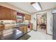 Kitchen area with wooden cabinets, countertop appliances, and natural lighting at 1027 Plum St # 39, Brownsburg, IN 46112
