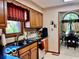 Charming kitchen with wooden cabinets, dark countertops, and a view to the adjacent dining area at 1027 Plum St # 39, Brownsburg, IN 46112