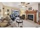 Cozy living room with a fireplace, comfortable seating, and a ceiling fan at 1027 Plum St # 39, Brownsburg, IN 46112