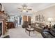 Spacious living area featuring plush seating, a ceiling fan, and access to the kitchen at 1027 Plum St # 39, Brownsburg, IN 46112