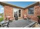 Cozy outdoor patio with lounge chairs, side tables, and brick siding at 1027 Plum St # 39, Brownsburg, IN 46112