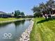 Scenic view of the property overlooking a pond with rocky shores and beautiful greenery at 1027 Plum St # 39, Brownsburg, IN 46112