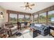 Bright sunroom with large windows, comfortable seating, and a ceiling fan at 1027 Plum St # 39, Brownsburg, IN 46112