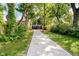Long cement walkway between mature trees to the house with a red door at 1038 W 33Rd St, Indianapolis, IN 46208