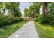 Long cement walkway stretches through the green backyard to the wooden fence at 1038 W 33Rd St, Indianapolis, IN 46208