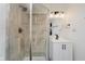 Bathroom featuring tiled shower, vanity with modern fixtures and lighting at 1038 W 33Rd St, Indianapolis, IN 46208