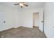 Neutrally decorated bedroom with a ceiling fan and two bright white doors at 1038 W 33Rd St, Indianapolis, IN 46208