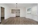 Bright dining room featuring wood-look flooring and views into the kitchen at 1038 W 33Rd St, Indianapolis, IN 46208
