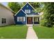 Charming two-story home with blue siding, white trim, and a well-manicured lawn at 1038 W 33Rd St, Indianapolis, IN 46208