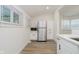 Bright kitchen features white cabinets and stainless steel refrigerator at 1038 W 33Rd St, Indianapolis, IN 46208