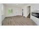 Inviting living area with modern electric fireplace, wood-look floors, and staircase at 1038 W 33Rd St, Indianapolis, IN 46208