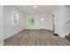 Bright living room features white walls, wood-look flooring, and abundant natural light from multiple windows at 1038 W 33Rd St, Indianapolis, IN 46208