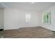 Neutral living space with wood-look floors, white walls, and natural lighting at 1038 W 33Rd St, Indianapolis, IN 46208