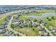 Stunning aerial view of homes surrounding a golf course and pond, offering scenic community living at 10471 Winghaven Dr, Noblesville, IN 46060