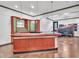Basement bar featuring decorative lighting, wood bar, and tile floors at 10471 Winghaven Dr, Noblesville, IN 46060