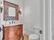 Powder room features a carved cabinet with marble counter and unique sconces at 10471 Winghaven Dr, Noblesville, IN 46060
