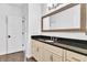 Bathroom featuring a vanity with black countertop and gold framed mirror at 10471 Winghaven Dr, Noblesville, IN 46060