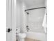 Bathroom featuring a tub with a shower, white fixtures, and neutral flooring at 10471 Winghaven Dr, Noblesville, IN 46060