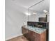 Bathroom featuring a glass countertop, dual sinks, and modern lighting fixtures at 10471 Winghaven Dr, Noblesville, IN 46060