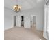 Bedroom featuring plush carpet, large windows, a chandelier, and access to a walk-in closet and ensuite bathroom at 10471 Winghaven Dr, Noblesville, IN 46060
