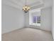 Bright, empty bedroom with tray ceilings, plush carpet, and a window seat by the window at 10471 Winghaven Dr, Noblesville, IN 46060