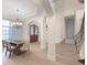 Open concept dining room and hallway featuring a chandelier, columns, and an arched entry at 10471 Winghaven Dr, Noblesville, IN 46060