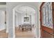 Elegant dining room featuring an arched doorway, tray ceiling, and chandelier at 10471 Winghaven Dr, Noblesville, IN 46060