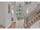 Elegant foyer showcasing high ceilings, a grand window, and wrought iron staircase at 10471 Winghaven Dr, Noblesville, IN 46060