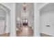 Spacious foyer featuring a staircase with wrought iron, arched doorways, and a chandelier at 10471 Winghaven Dr, Noblesville, IN 46060